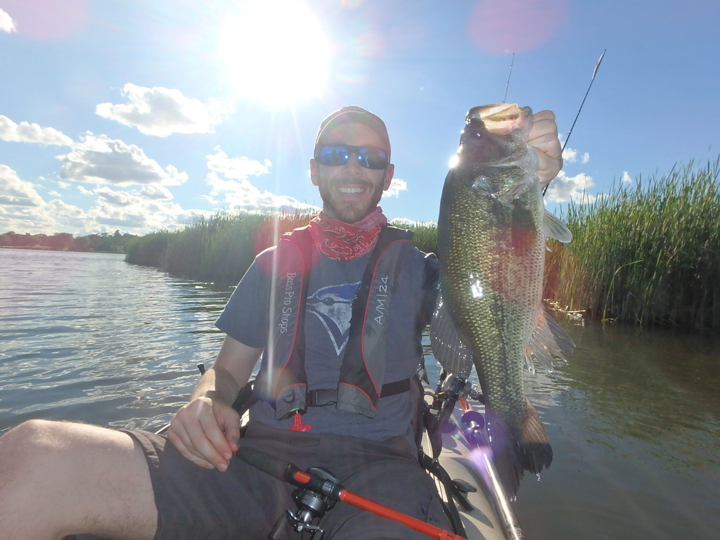 Matthew Randall holding a large largemouth bass.