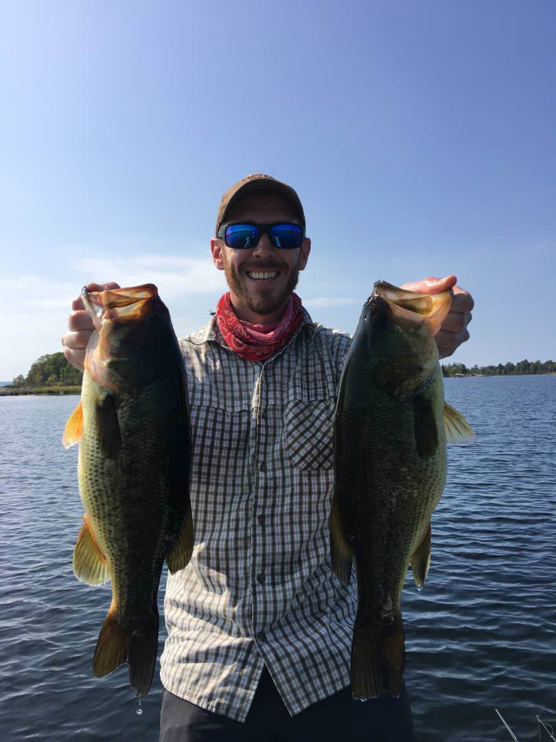 Matthew Randall fishing Georgian Bay on September 25, 2017, holding 2 fish and smiling