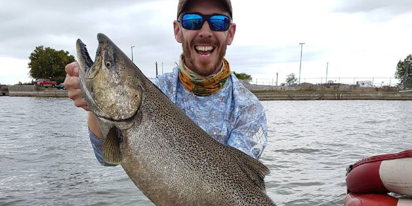 Matthew Randall holding a large salmon.