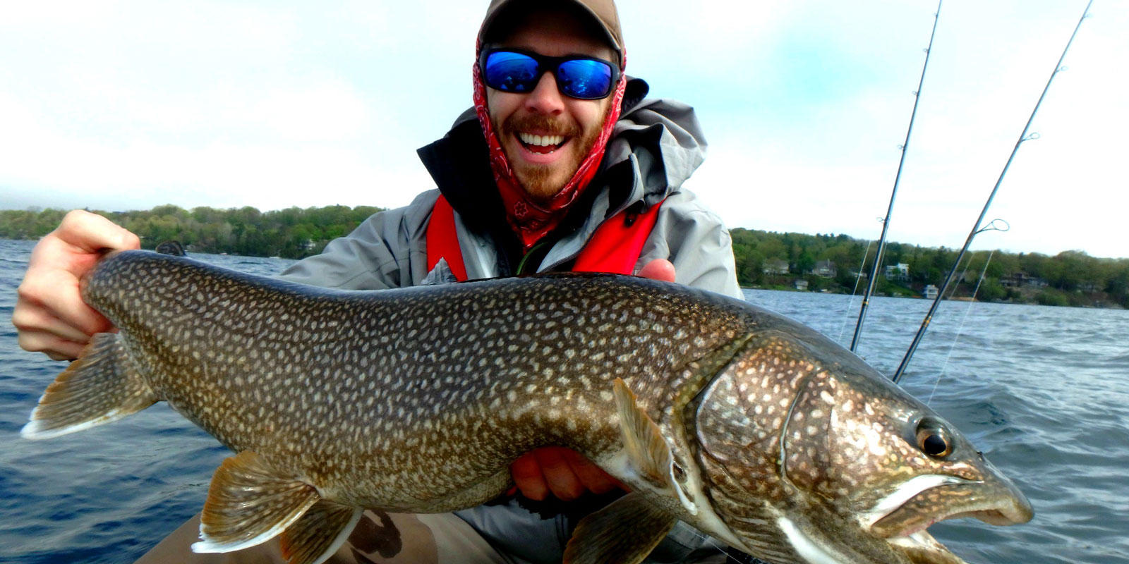 Matthew Randall holding a large lake trout on Lake Simcoe.