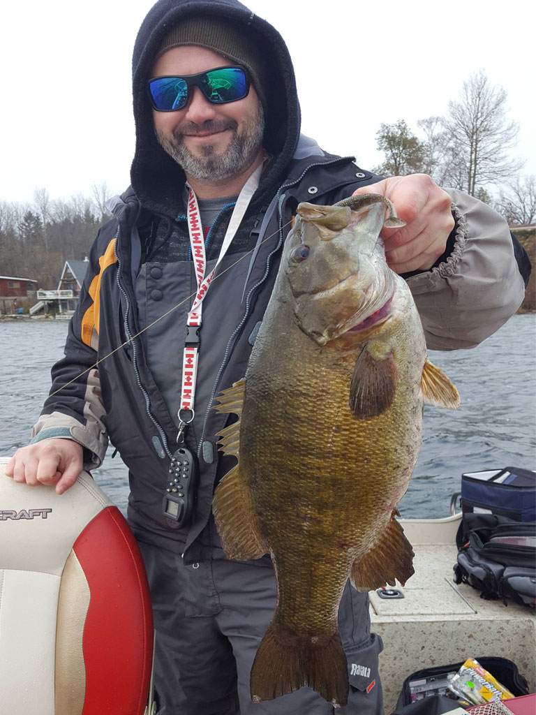 Matthew Randall's buddy Mike Wilson with a large bass on lake Simcoe.