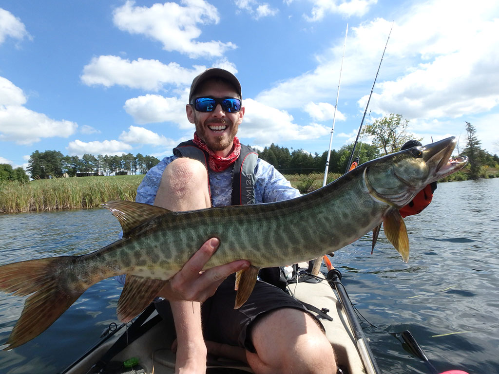 Matthew Randall with a large musky on the Otonabee River.