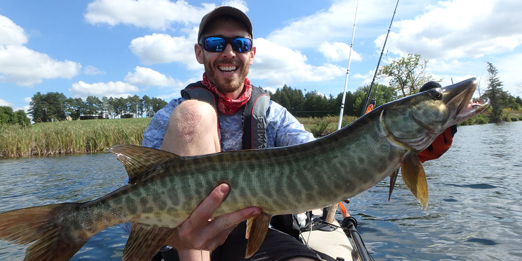 Matthew Randall holding a huge musky.