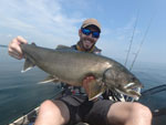 Matthew Randall holding a large Lake Trout on Lake Simcoe.