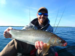 Matthew Randall holding a large Whitefish on Lake Simcoe.