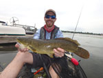 Matthew Randall's holding a bowfin, side shot.