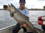 Matthew Randall holding a massive salmon in Lake Ontario