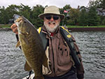 Matthew Randall's dad holding a smallmouth bass.